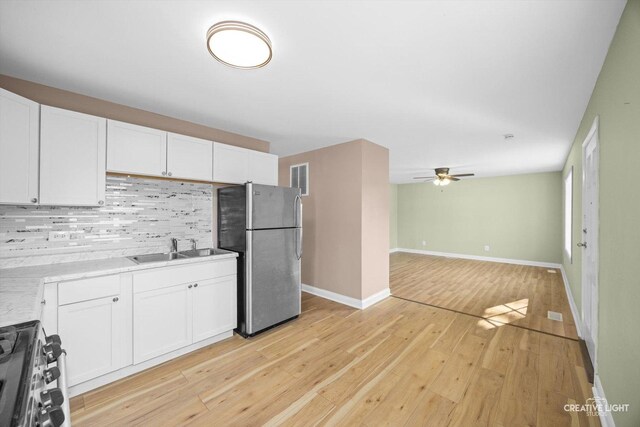 1806 E Sauk Trl, Sauk Village, IL 60411 - kitchen with freestanding refrigerator, stove, decorative backsplash, and white cabinets