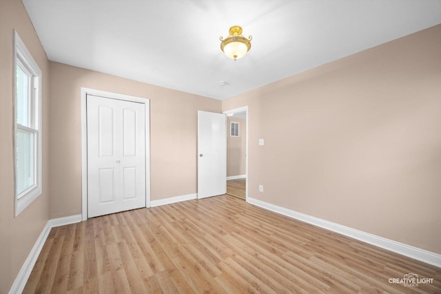 1806 E Sauk Trl, Sauk Village, IL 60411 - unfurnished bedroom with light wood finished floors and a closet
