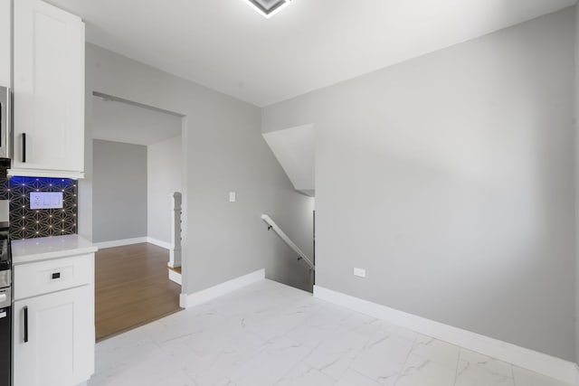 18 Orchard St, Hillside, IL 60162 - kitchen featuring light marble finish flooring, white cabinets, light countertops, and backsplash