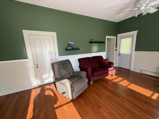 325 E Waupansie St, Dwight, IL 60420 - living room with a wainscoted wall, wood finished floors, a ceiling fan, and a baseboard radiator