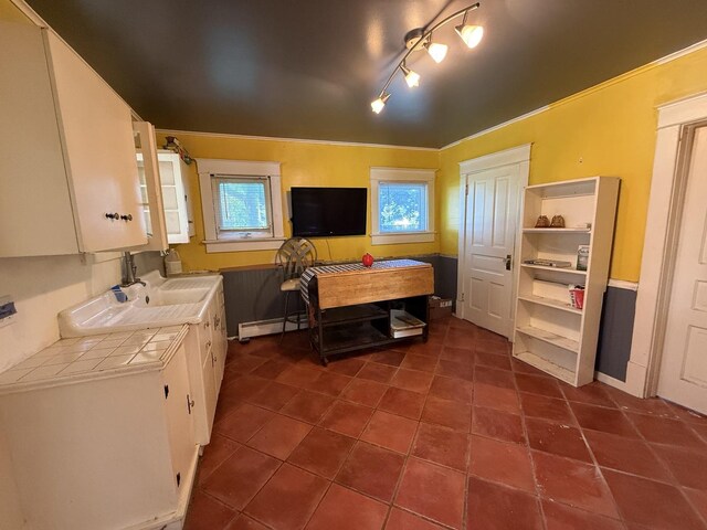 325 E Waupansie St, Dwight, IL 60420 - kitchen with tile countertops, white cabinets, baseboard heating, open shelves, and dark tile patterned flooring