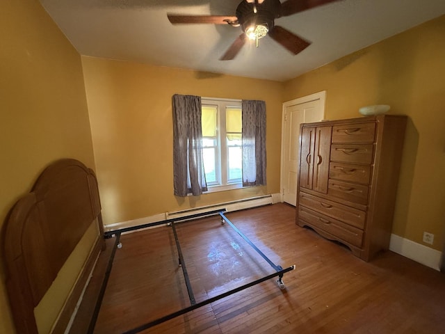 325 E Waupansie St, Dwight, IL 60420 - bedroom featuring wood finished floors, a baseboard radiator, and ceiling fan