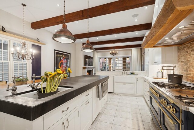 1414 N Mohawk St, Chicago, IL 60610 - kitchen with premium range hood, double oven range, a chandelier, beamed ceiling, and white cabinets