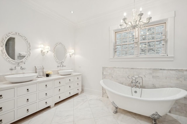 1414 N Mohawk St, Chicago, IL 60610 - bathroom with a chandelier, double vanity, crown molding, a soaking tub, and marble finish floors