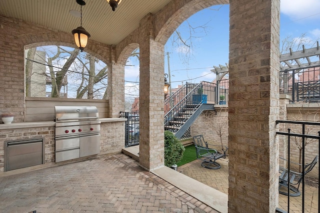 1414 N Mohawk St, Chicago, IL 60610 - view of patio featuring an outdoor kitchen and stairs