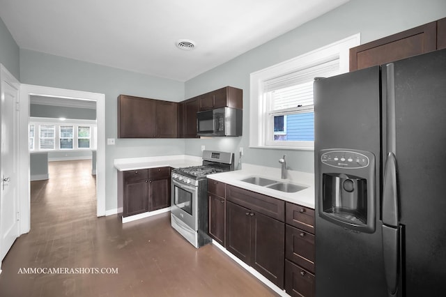 11402 S Calumet Ave, Chicago, IL 60628 - kitchen featuring fridge with ice dispenser, stainless steel range with gas cooktop, black microwave, light countertops, and dark brown cabinetry