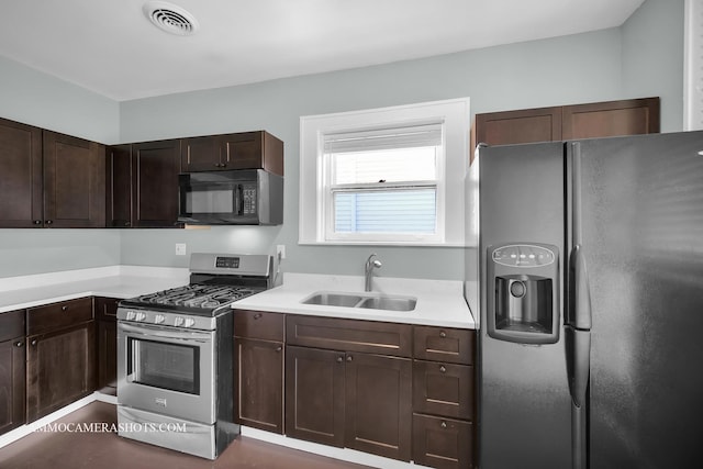 11402 S Calumet Ave, Chicago, IL 60628 - kitchen featuring fridge with ice dispenser, stainless steel range with gas stovetop, black microwave, light countertops, and dark brown cabinetry