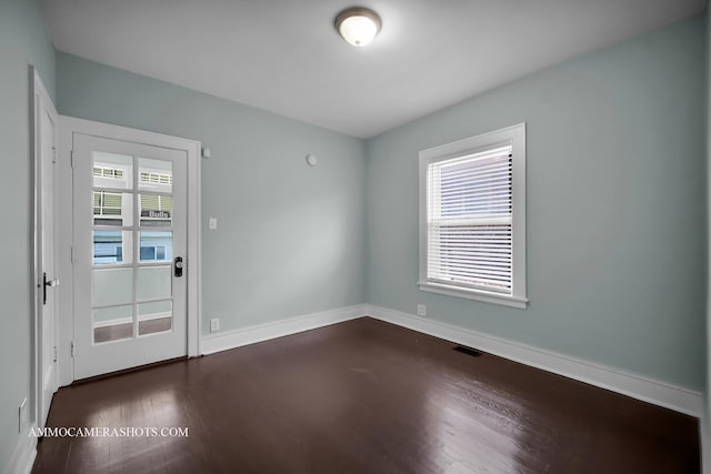 11402 S Calumet Ave, Chicago, IL 60628 - empty room featuring dark wood-style floors and baseboards