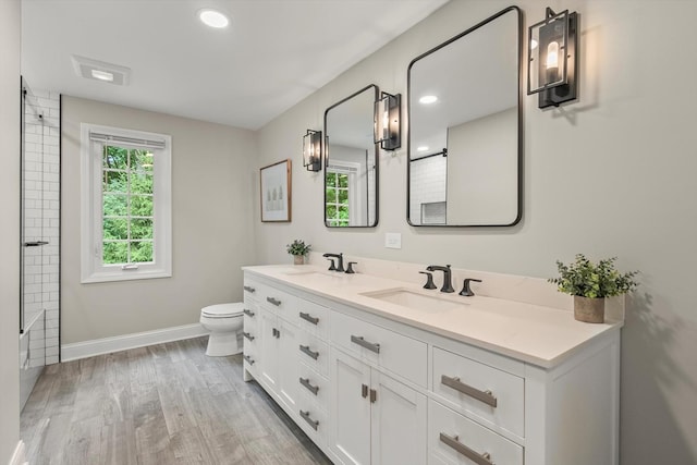 124 Hidden Oaks Dr, Barrington, IL 60010 - full bathroom featuring double vanity, wood finished floors, and bathing tub / shower combination