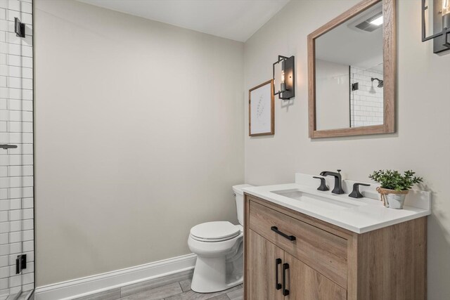 124 Hidden Oaks Dr, Barrington, IL 60010 - full bath featuring vanity, tiled shower, and wood finished floors