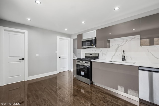 12830 S Carpenter St, Calumet Park, IL 60827 - kitchen with appliances with stainless steel finishes, modern cabinets, gray cabinetry, backsplash, and recessed lighting