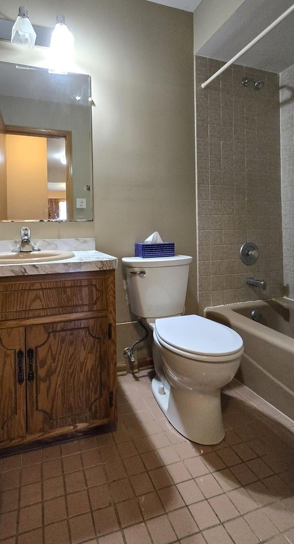 7121 Oak Grove Ave, Justice, IL 60458 - bathroom featuring tile patterned flooring, shower / washtub combination, and vanity
