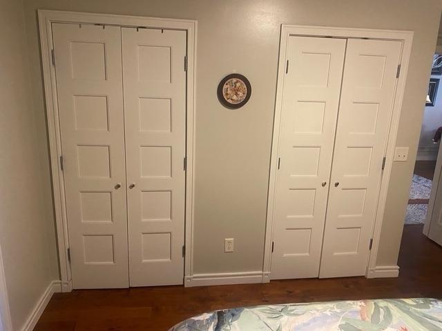 212 N Center St Unit 205, Bloomington, IL 61701 - unfurnished bedroom with baseboards and dark wood finished floors