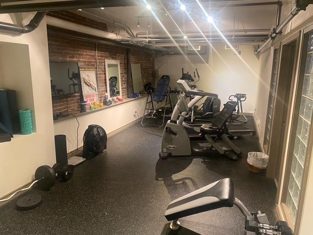212 N Center St Unit 205, Bloomington, IL 61701 - exercise room with brick wall