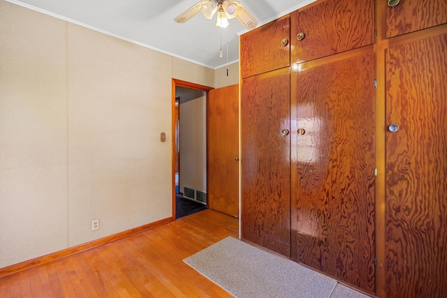 1716 Court St, Mchenry, IL 60050 - unfurnished bedroom featuring light wood finished floors, ornamental molding, and ceiling fan