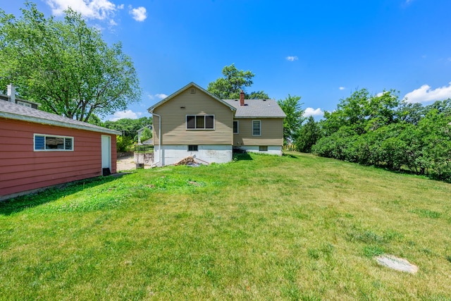 1716 Court St, Mchenry, IL 60050 - rear view of house featuring a lawn