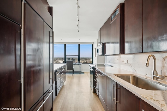 1560 N Sandburg Ter Unit 4301-4303, Chicago, IL 60610 - kitchen with appliances with stainless steel finishes, light wood-style flooring, dark brown cabinetry, and modern cabinets