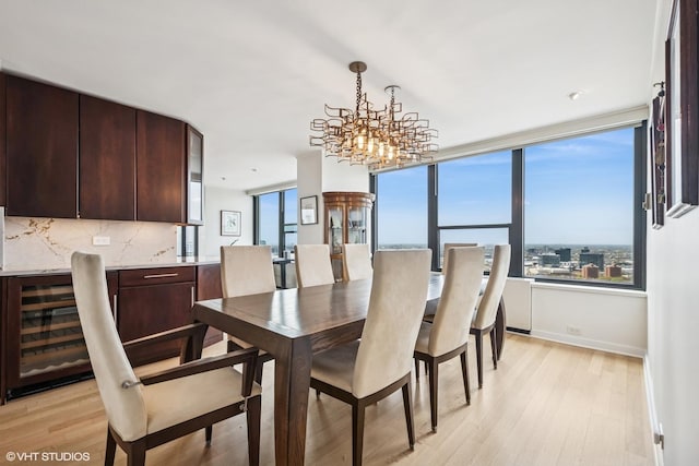1560 N Sandburg Ter Unit 4301-4303, Chicago, IL 60610 - dining room featuring beverage cooler, light wood finished floors, and a chandelier