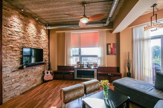 3201 W Leland Ave Unit 406, Chicago, IL 60625 - living area featuring track lighting, wood finished floors, a ceiling fan, and plenty of natural light