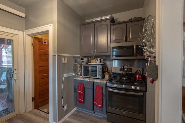 96 Interocean Ave, South Chicago Heights, IL 60411 - kitchen featuring stainless steel appliances, wood finished floors, and gray cabinetry