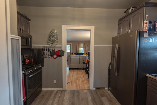 96 Interocean Ave, South Chicago Heights, IL 60411 - kitchen featuring appliances with stainless steel finishes, wood finished floors, and a wainscoted wall