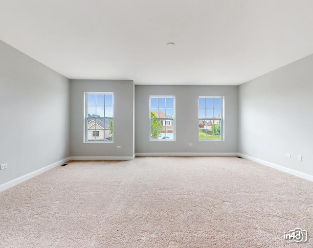 24433 W Bantry Ln, Shorewood, IL 60404 - spare room featuring baseboards and light colored carpet