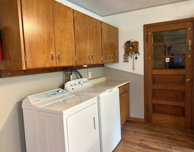 1217 Retz Dr, Ottawa, IL 61350 - washroom featuring cabinet space, washing machine and dryer, wood finished floors, and a textured ceiling