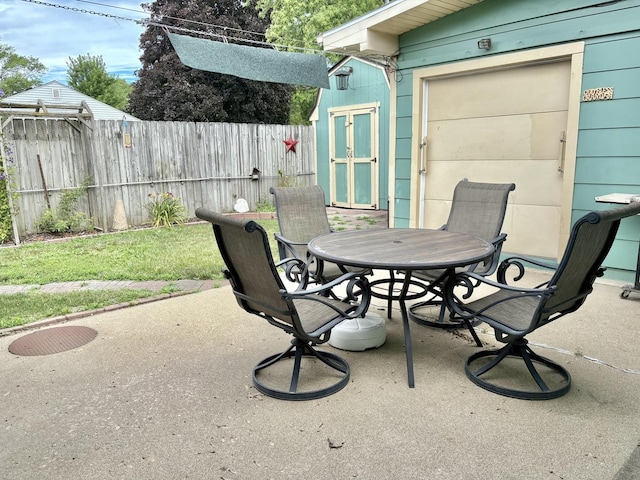 1217 Retz Dr, Ottawa, IL 61350 - fenced backyard with outdoor dining space, a patio, and a shed