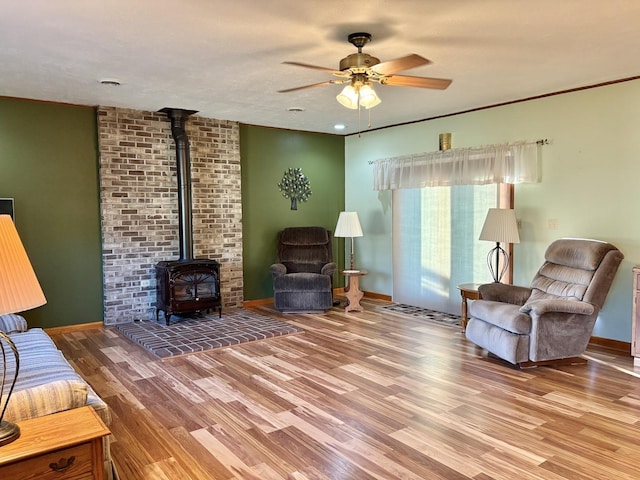 1217 Retz Dr, Ottawa, IL 61350 - living area featuring a wood stove, ceiling fan, and wood finished floors