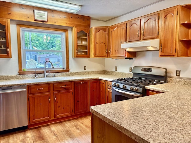 1217 Retz Dr, Ottawa, IL 61350 - kitchen with stainless steel appliances, under cabinet range hood, open shelves, light wood-type flooring, and light countertops