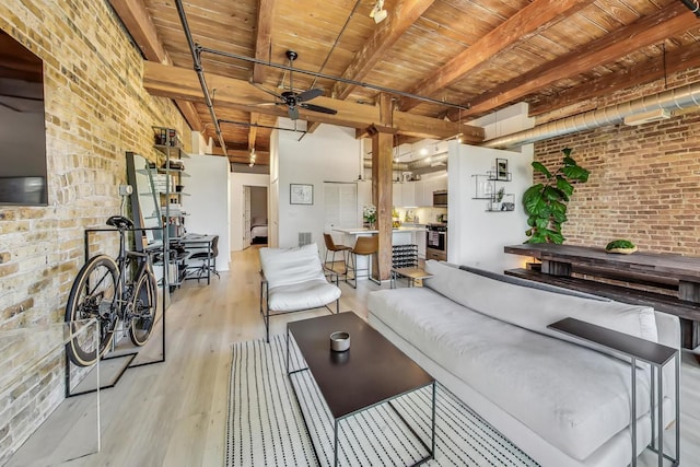 1740 N Maplewood Ave Unit 301, Chicago, IL 60647 - living area featuring a wooden ceiling with exposed beams, brick wall, wood finished floors, and ceiling fan
