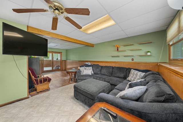 2689 Lynnville Ct, Lindenwood, IL 61049 - living room featuring wainscoting, ceiling fan, wooden walls, and beam ceiling