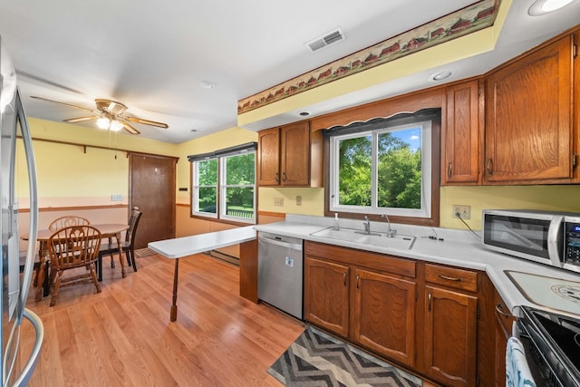 2689 Lynnville Ct, Lindenwood, IL 61049 - kitchen with stainless steel appliances, light wood finished floors, light countertops, and ceiling fan
