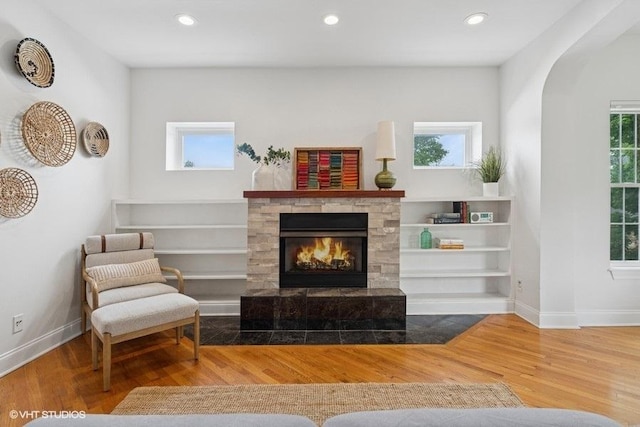 4637 N Drake Ave Unit 3, Chicago, IL 60625 - living area featuring a tiled fireplace, wood finished floors, recessed lighting, and arched walkways