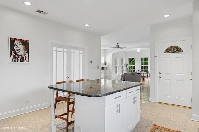 4637 N Drake Ave Unit 3, Chicago, IL 60625 - kitchen featuring recessed lighting, a kitchen breakfast bar, white cabinetry, a kitchen island, and dark stone countertops