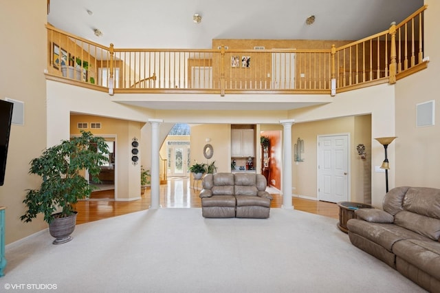 484 W Haleys Hill Ct, Palatine, IL 60074 - living room featuring ornate columns, a towering ceiling, and wood finished floors