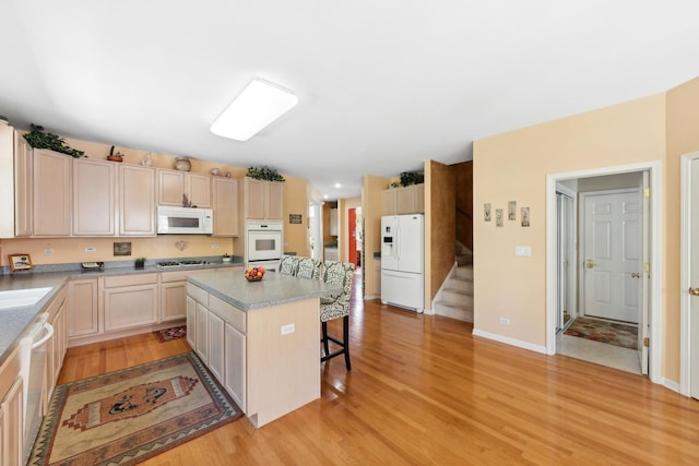 484 W Haleys Hill Ct, Palatine, IL 60074 - kitchen with white appliances, a breakfast bar area, light wood-type flooring, a center island, and light countertops