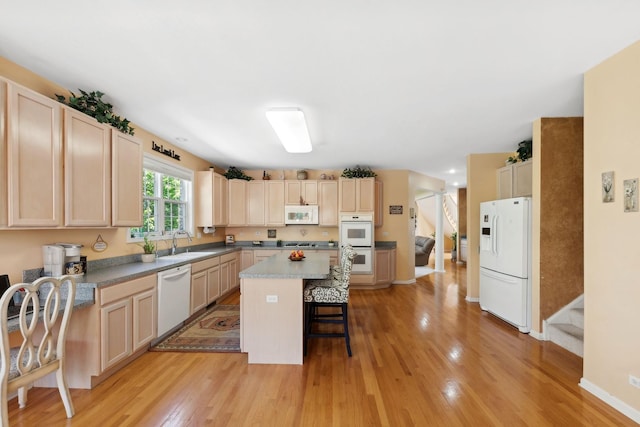 484 W Haleys Hill Ct, Palatine, IL 60074 - kitchen featuring white appliances, a center island, a breakfast bar area, light wood-style flooring, and light brown cabinets