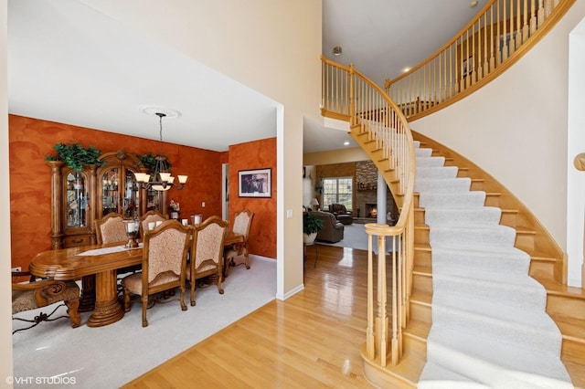 484 W Haleys Hill Ct, Palatine, IL 60074 - dining room with stairs, a chandelier, wood finished floors, and a towering ceiling