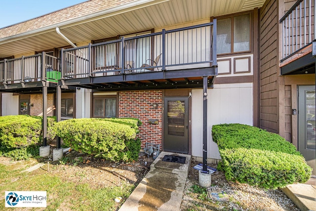 1137 Court A Dr, Hanover Park, IL 60133 - property entrance with a balcony and brick siding