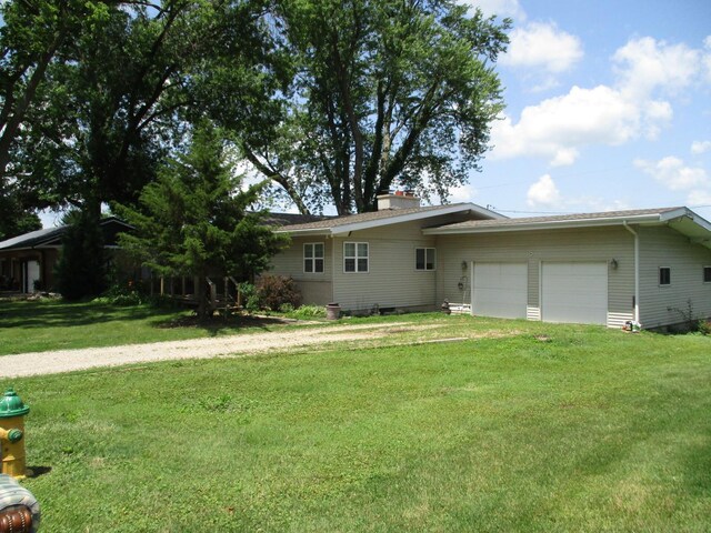 1110 Wacker Dr, Ottawa, IL 61350 - rear view of property featuring a garage, a yard, a chimney, and driveway