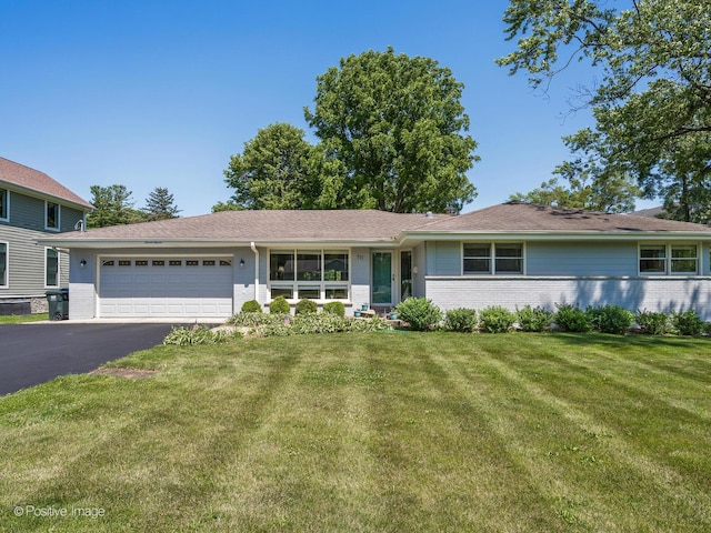711 Bryant Ave, Barrington, IL 60010 - view of front of house with brick siding, an attached garage, a front yard, and driveway