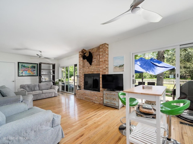 711 Bryant Ave, Barrington, IL 60010 - living area featuring a ceiling fan, light wood-type flooring, and a brick fireplace
