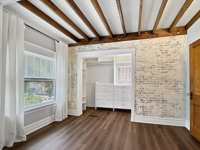 2423 Collins St, Blue Island, IL 60406 - unfurnished bedroom with dark wood-style floors, beamed ceiling, and brick wall