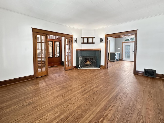 2423 Collins St, Blue Island, IL 60406 - unfurnished living room featuring french doors, wood finished floors, and a fireplace