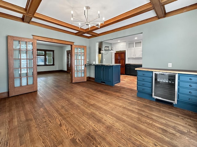 2423 Collins St, Blue Island, IL 60406 - kitchen with wine cooler, coffered ceiling, blue cabinets, white cabinets, and a chandelier