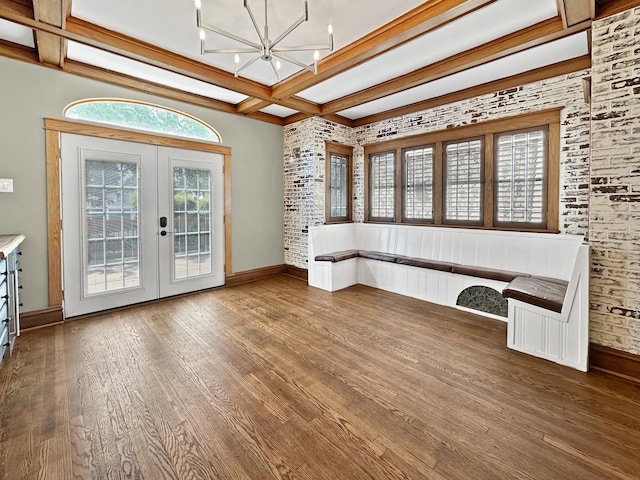 2423 Collins St, Blue Island, IL 60406 - unfurnished dining area featuring coffered ceiling, french doors, wood finished floors, beamed ceiling, and a chandelier