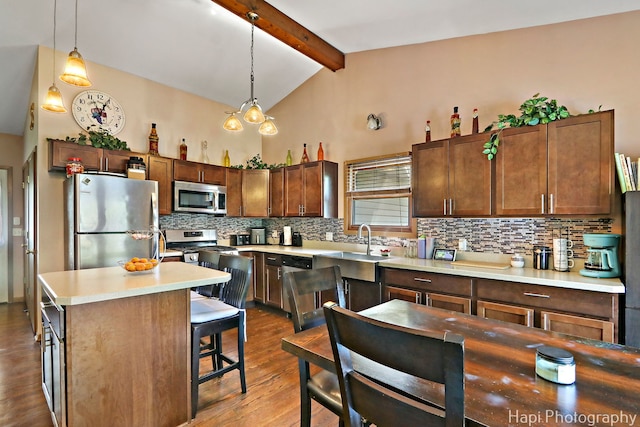 7523 Hickory, Wonder Lake, IL 60097 - kitchen featuring appliances with stainless steel finishes, wood finished floors, tasteful backsplash, light countertops, and a kitchen breakfast bar