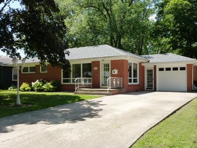 503 S Wilson St, Clinton, IL 61727 - single story home with an attached garage, brick siding, driveway, and a front lawn