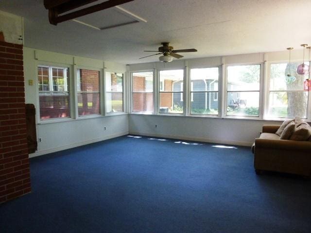 503 S Wilson St, Clinton, IL 61727 - unfurnished sunroom featuring a ceiling fan and carpet flooring